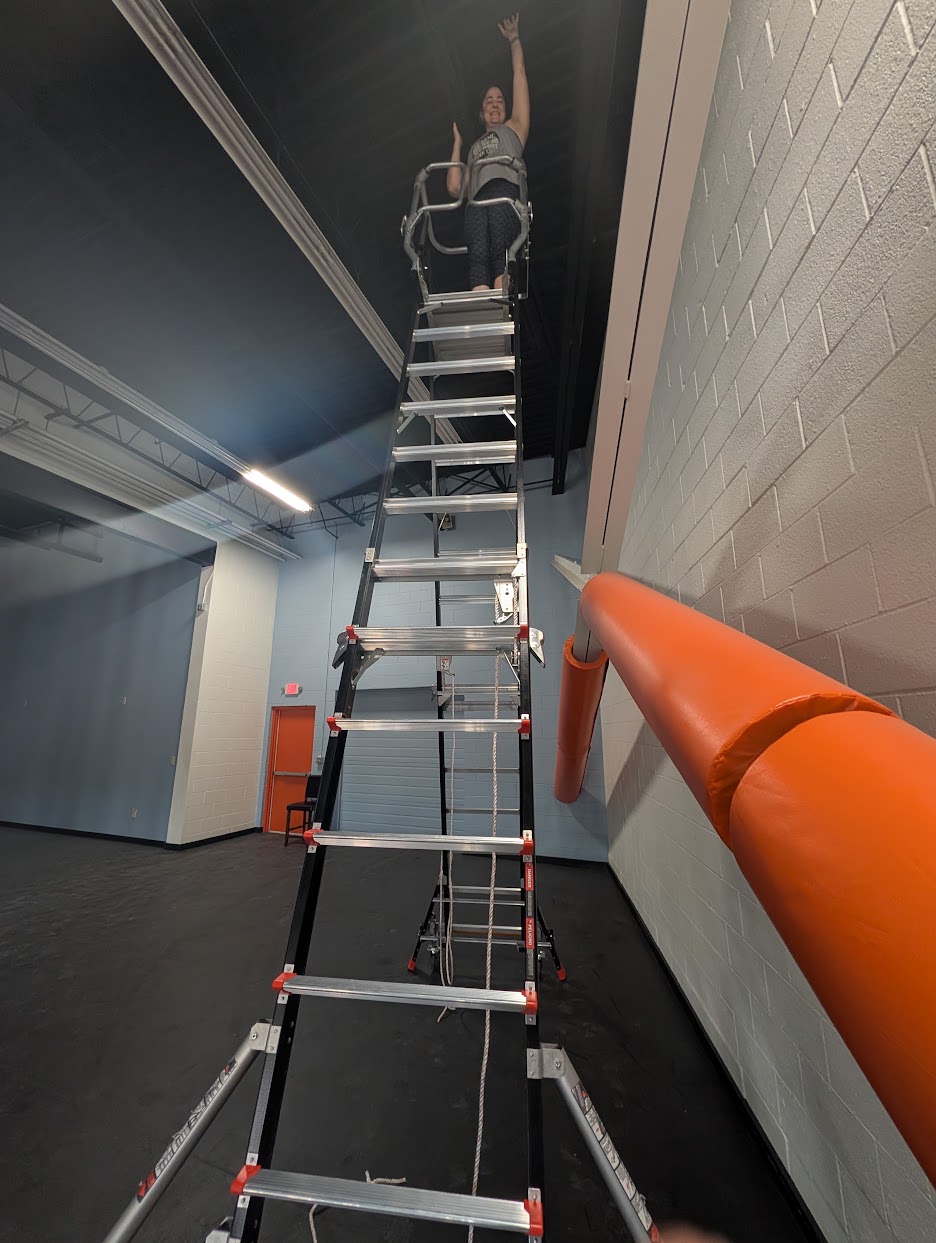 Coryn evaluating rigging height in the new Physio Flows studio space