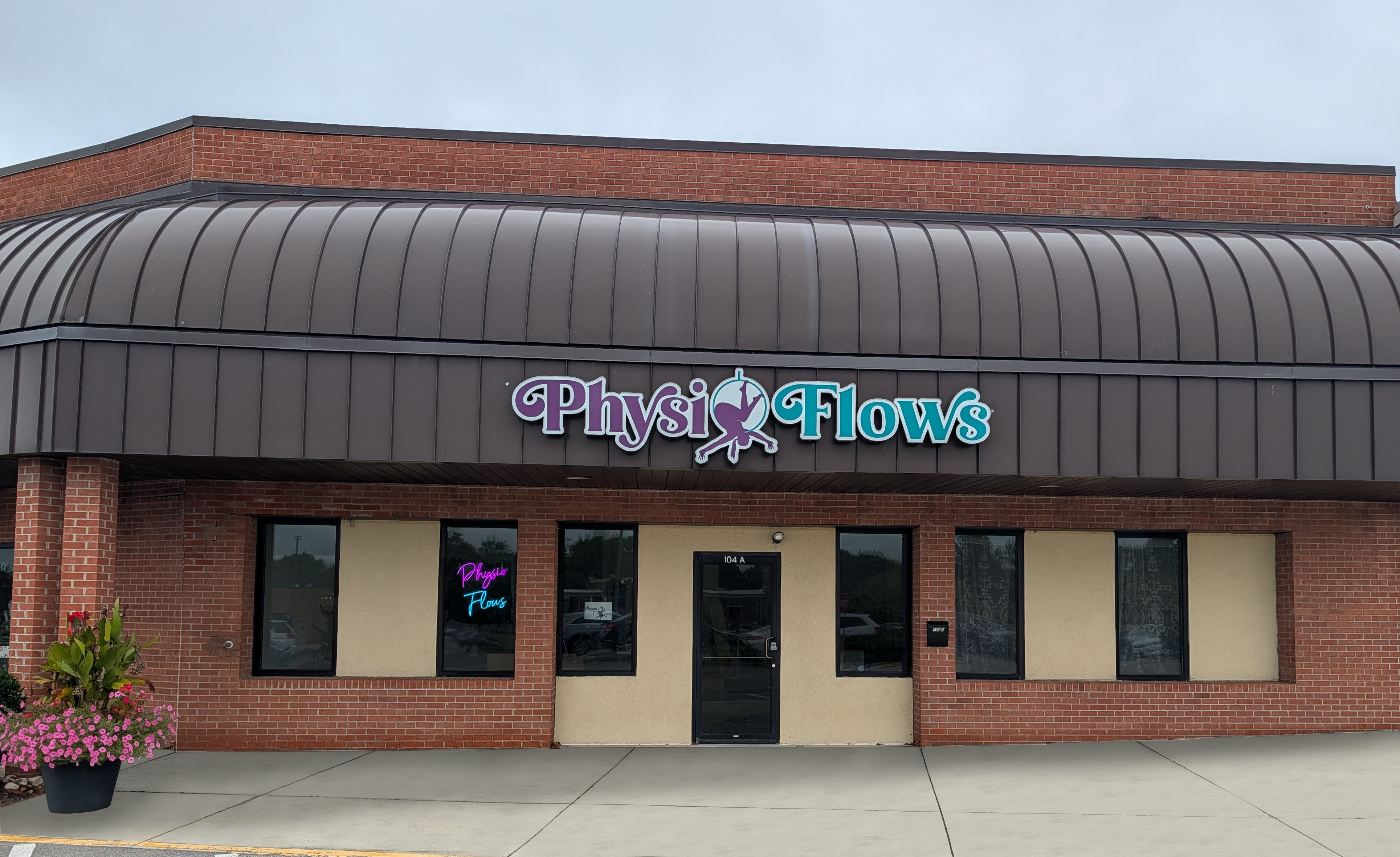 Exterior of the Physio Flows location at Cross Pointe Shopping Center in Centerville, Ohio, showing the storefront and sign.